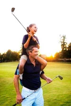 Dad and daughter golfing