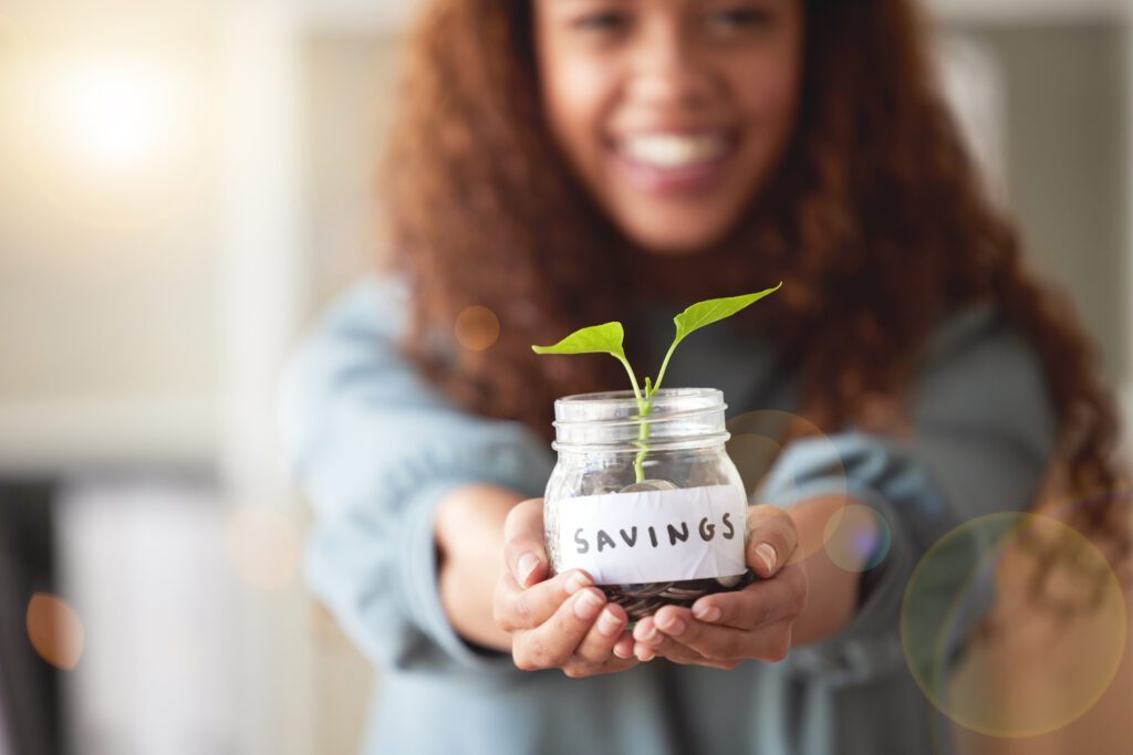 woman holding savings jar 