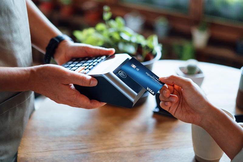 Woman tapping card on a card reader