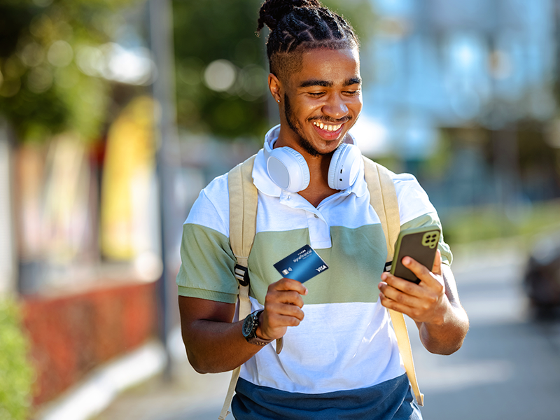 Young man using his card to pay for an online purchase