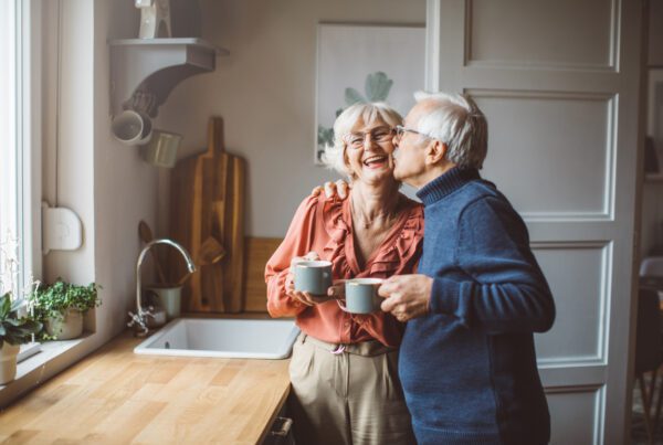 Elder couple enjoying a cup of coffee in their kitchen