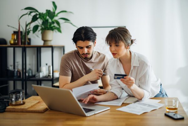 Couple paying bills on their laptop