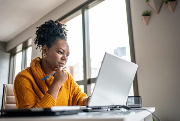 Woman looking at her laptop making financial decisions