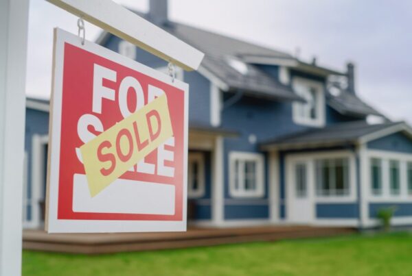 Sold sticker on top of a for sale sign
