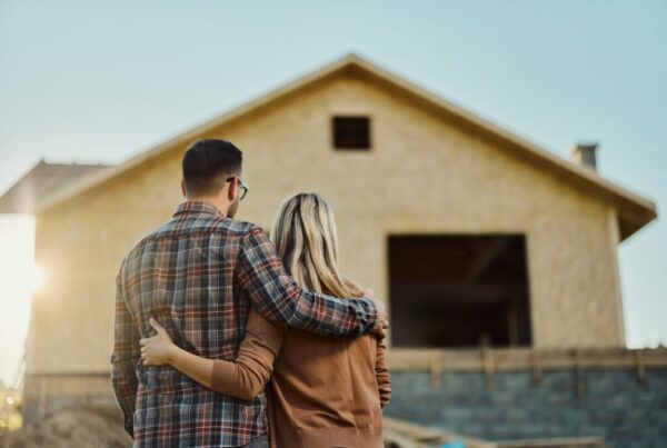 Couple looking at their new house being built