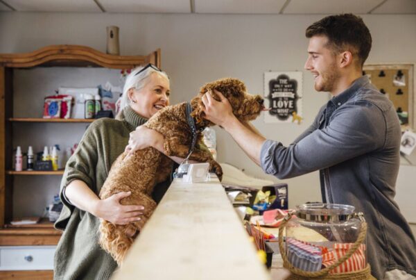 Elderly woman dropping her dog off for grooming