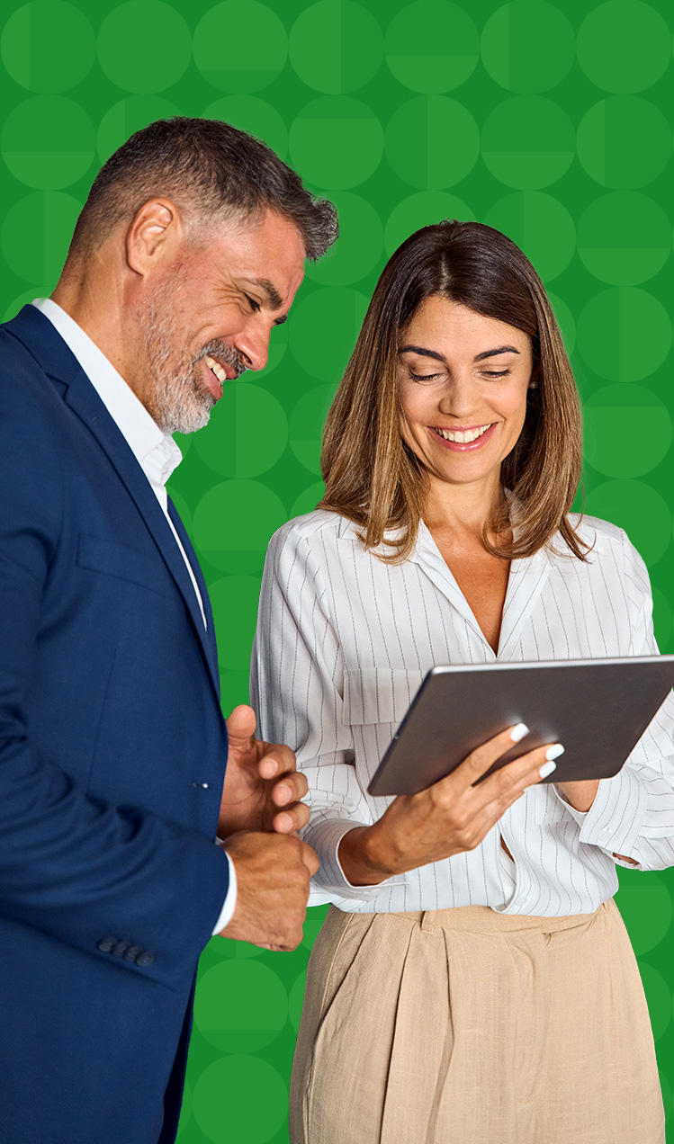 Two businesspeople looking at a tablet after a meeting