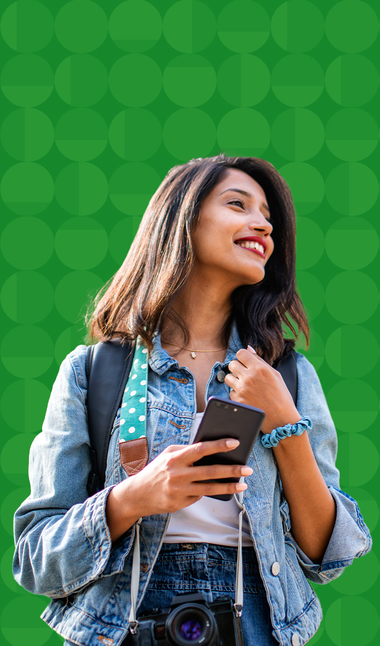 Young traveler with a phone in hand and camera around her neck