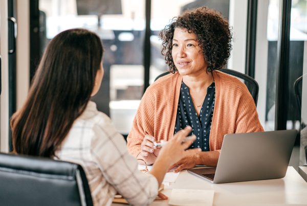 Two women discussing strategy