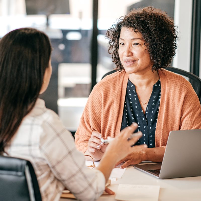 Two women discussing strategy