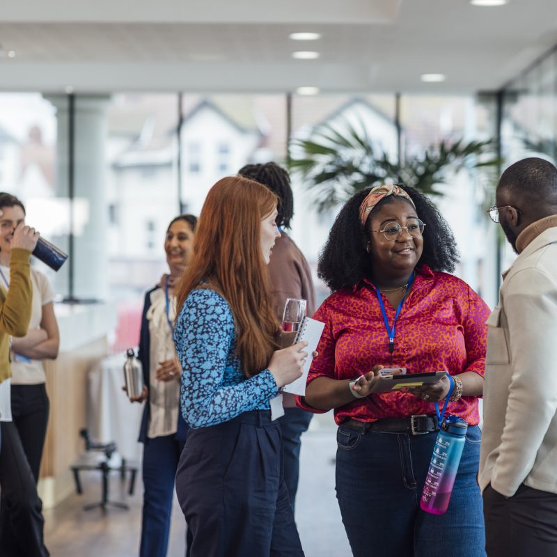 Group of diverse individuals networking at a social event.