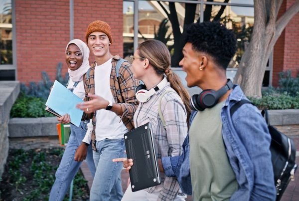 Group of college students walking on campus.