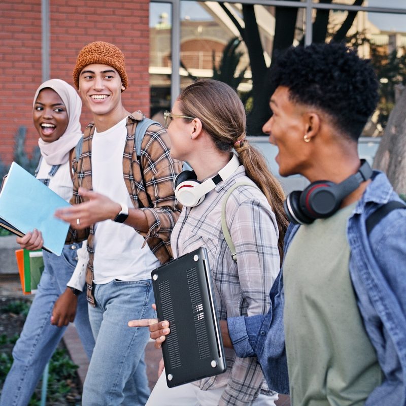 Group of college students walking on campus.