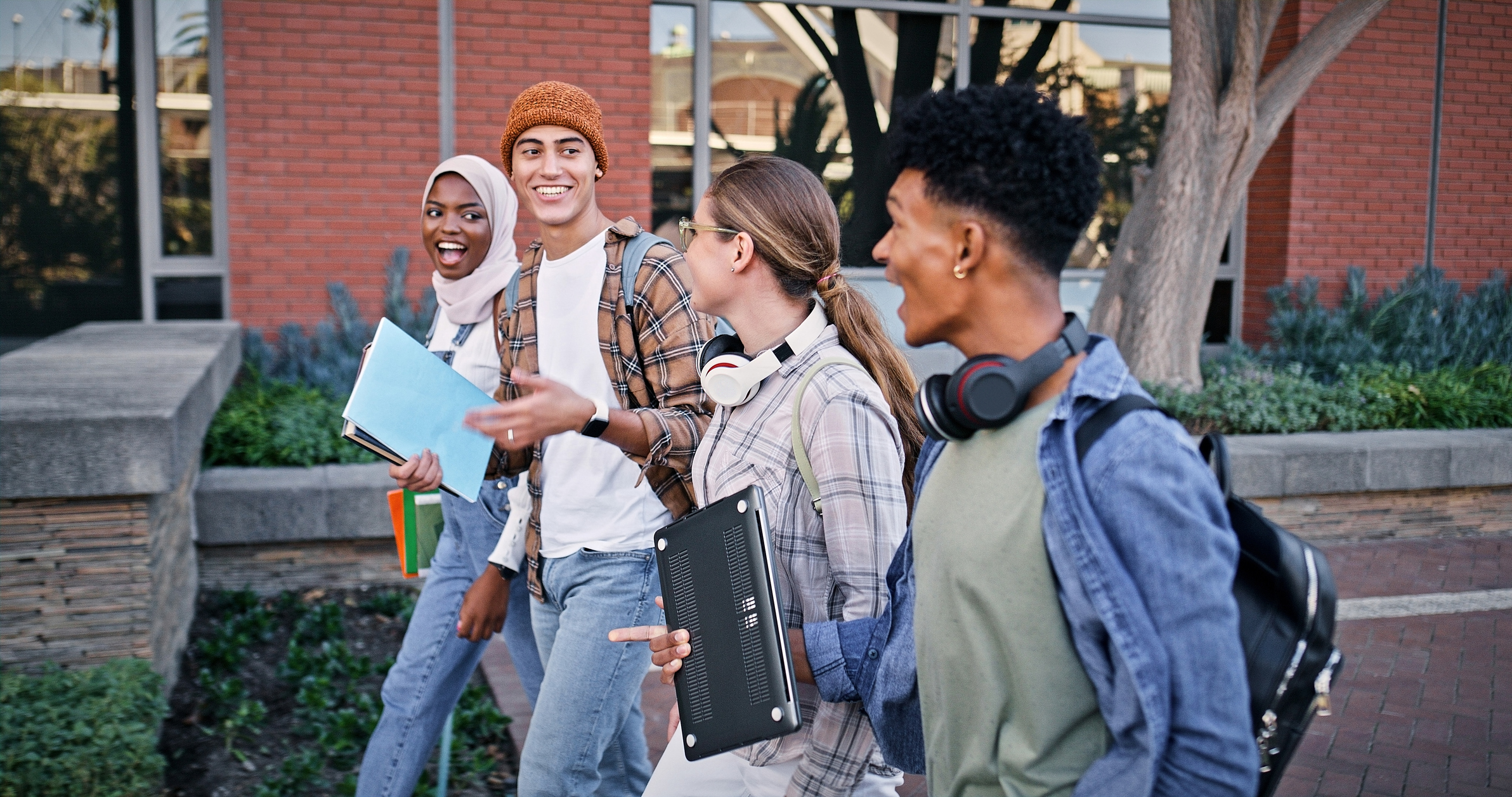 Group of college students walking on campus.