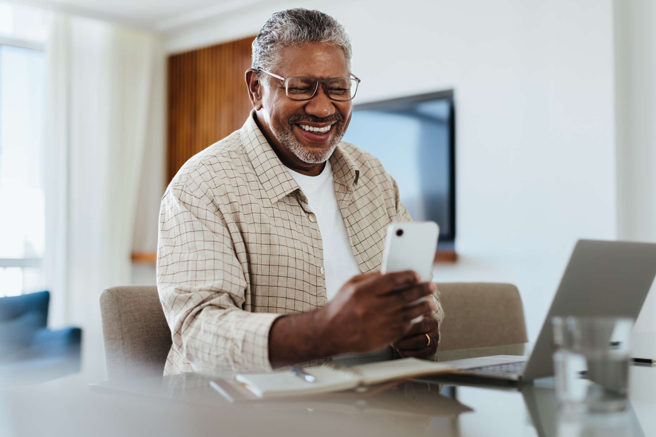 Happy male using phone for connecting and staying in touch