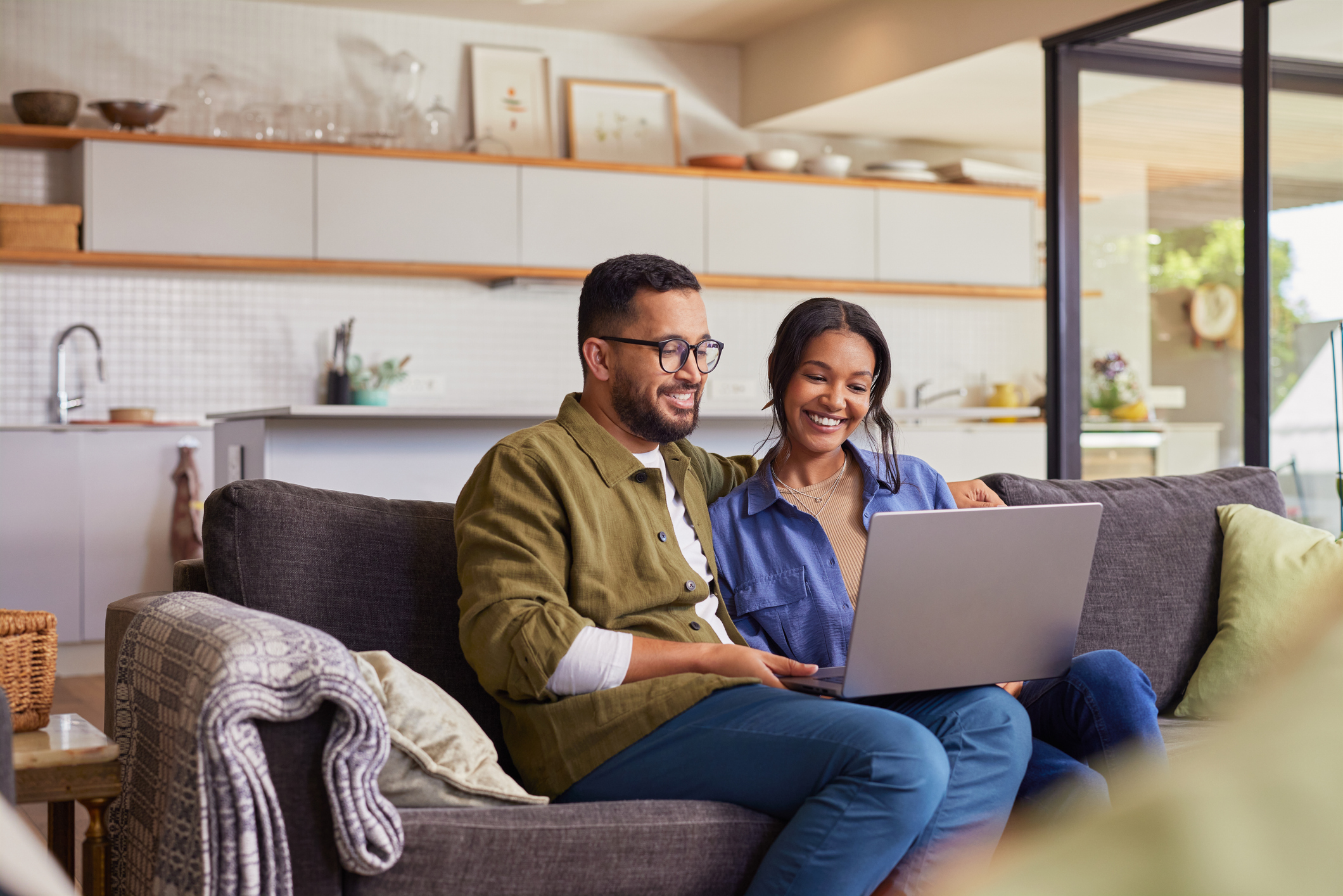 Couple using laptop at home