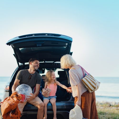 Happy Family Vacation Together by the Scenic Sea During Summer