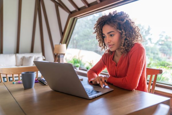 Young woman working at home using her laptop computer