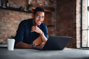 Young Professional Working on Laptop in Modern Office Setting
