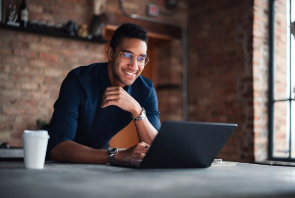 Young Professional Working on Laptop in Modern Office Setting