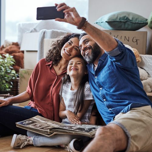 Happy Family Taking a Selfie at Their New Home During Moving Day